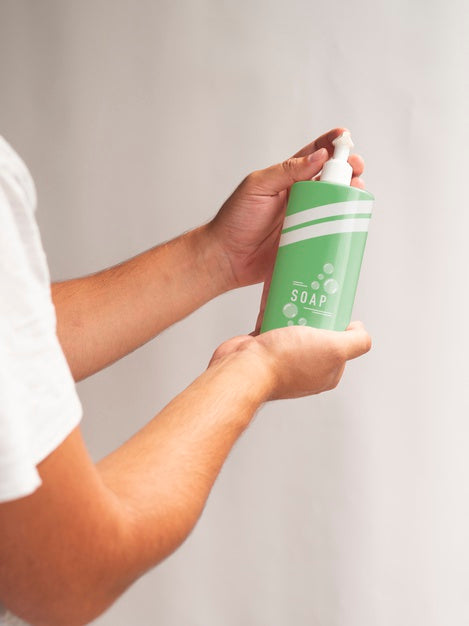 Person Holding A Liquid Soap Bottle Psd