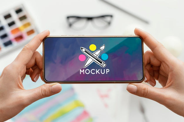 Person Holding A Mock-Up Smartphone Psd