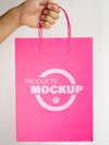 Person Holding A Pink Paper Bag Psd