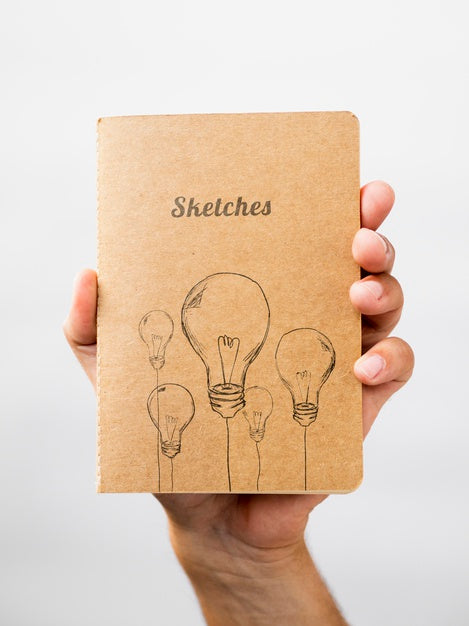 Person Holding A Sketch Book Psd