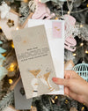 Person Holding Card With Envelope Next To Christmas Ornaments Psd