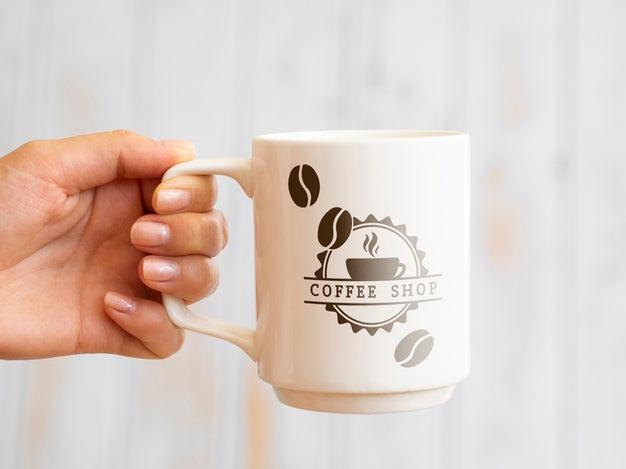 Person Holding Up A Coffee Mug Psd