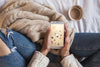 Person On Bed Looking At Smartphone With Autumn Concept Psd