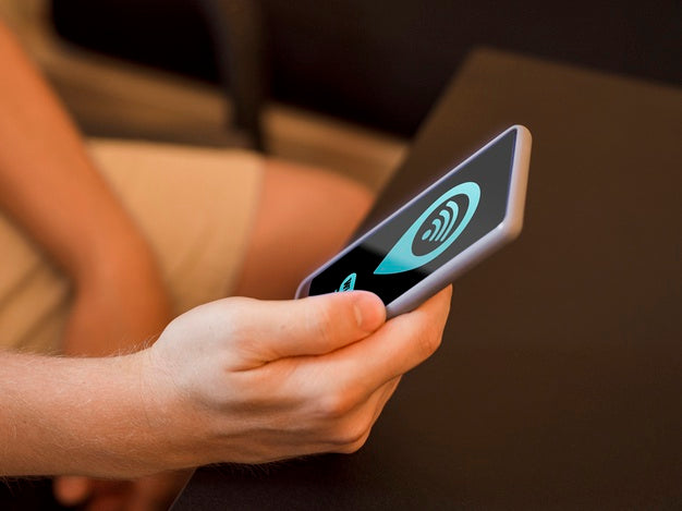 Person Sitting And Holding His Smartphone Psd