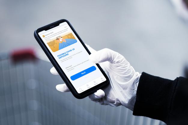 Phone Mockup With Person Wearing Gloves And Holding The Device Psd