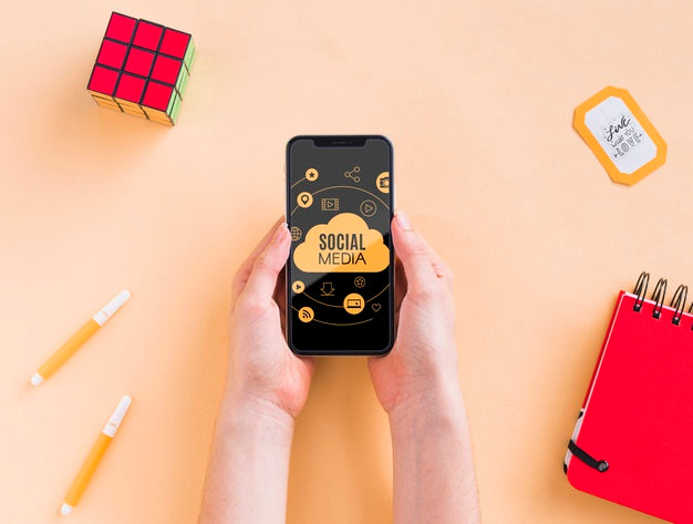 Phone On Desk Beside Rubik Cube Psd