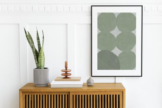 Picture Frame Mockup Hanging Above A Wooden Cabinet Psd