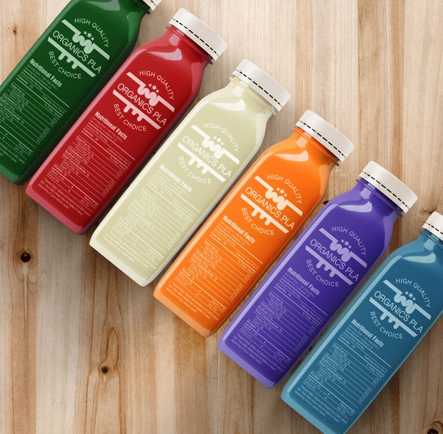 Plastic Bottles With Different Fruit Or Vegetable Juices Top View Psd