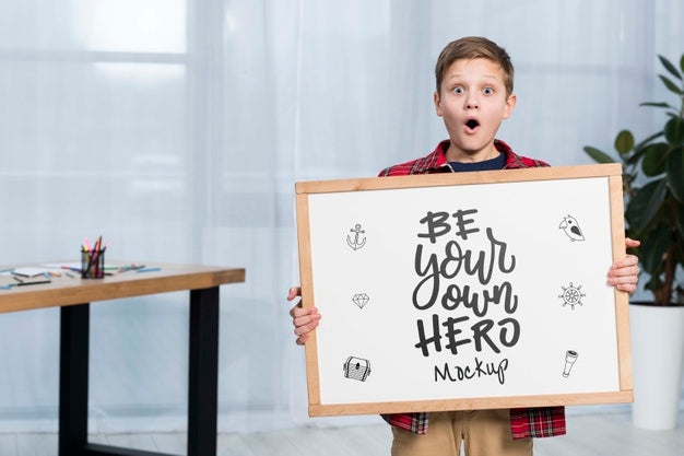 Portrait Of Child Holding Mock-Up Sign Psd