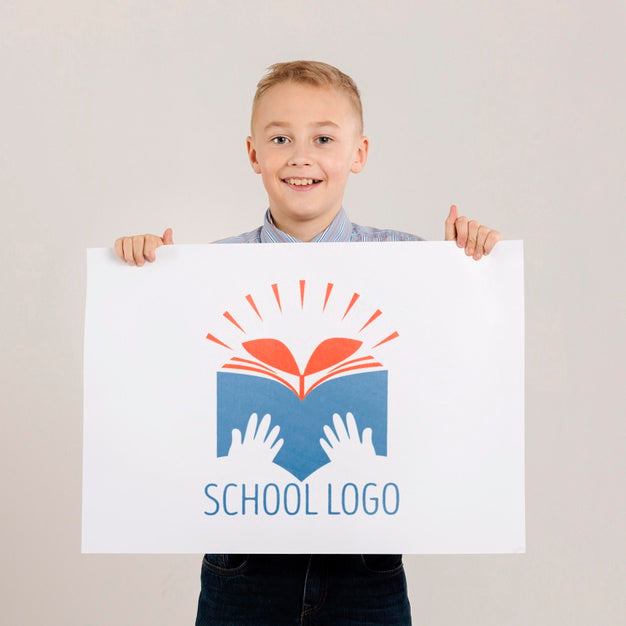 Portrait Of Happy Boy Holding Mock-Up Sign Psd