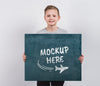 Portrait Of Young Boy Holding Mock-Up Sign Psd