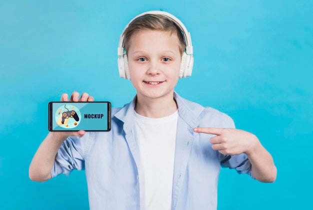 Portrait Of Young Boy Holding Phone With Mock-Up Psd