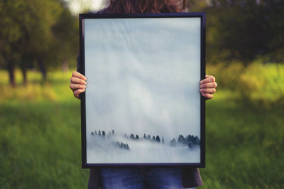 Women Holding a Poster Frame Mockup