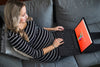 Pregnant Woman On Couch Using Computer Psd