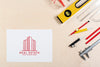Real Estate Logo With Buildings And Stationery Items Psd