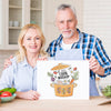Senior Couple In Kitchen Holding Cardboard Mock-Up Psd