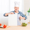 Senior Male In Kitchen Holding Paper Mock-Up Psd