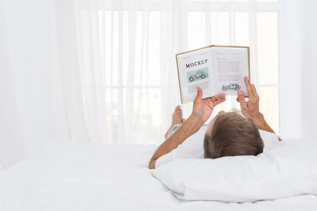 Senior Man Reading In Bed Psd