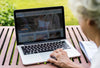 Senior Woman Using A Laptop On Vacation Psd