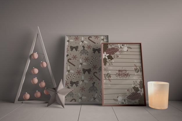 Set Of Paintings On Floor Beside Miniature Christmas Tree Psd