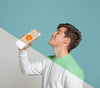 Side View Of Man Drinking Out Of Juice Carton Psd