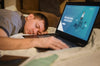 Side View Of Man Falling Asleep While Working On Laptop Psd