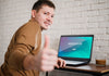 Side View Of Man Giving Thumbs Up While Working From Home Psd