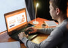 Side View Of Man Working From Home On Laptop Psd