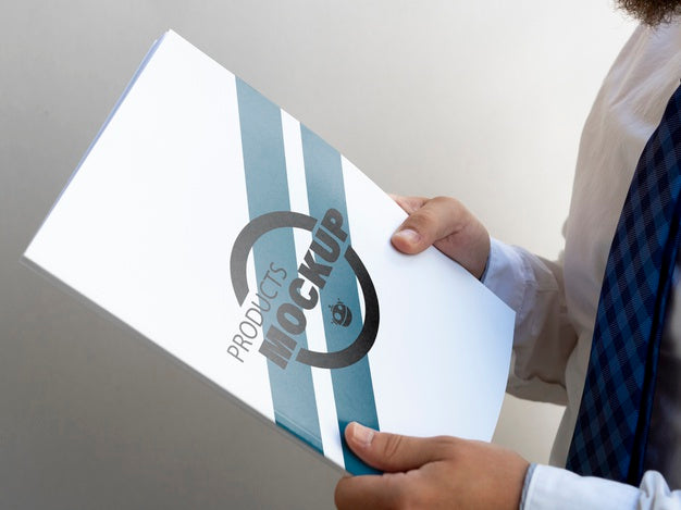 Sideways Man Holding A Notebook Mock-Up Psd