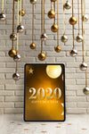 Silver And Golden Hanging Globes On Top Of Tablet Psd