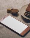 Smartphone And A Tasty Cake On A Table