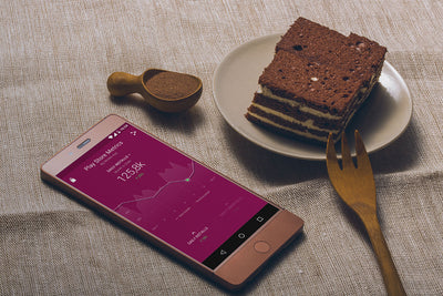 Smartphone and Tasty Cake on a Table
