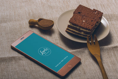Smartphone and Tasty Cake on a Table