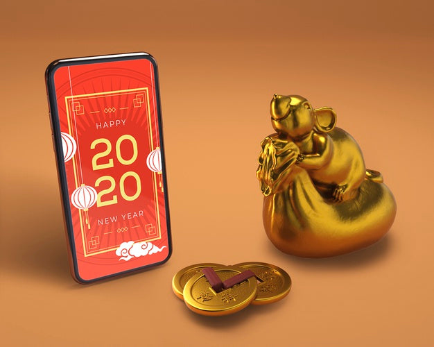 Smartphone Beside Golden Statue For New Year Psd