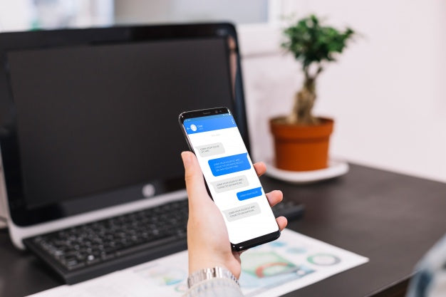 Smartphone Mockup In Front Of Computer Psd