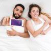 Smartphone Mockup With Couple In Bed Psd