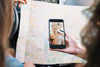 Smartphone Mockup With Girls Looking At Map Psd