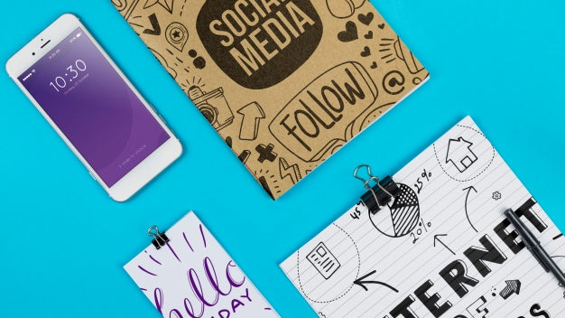 Smartphone Mockup With Office Materials On Table Psd