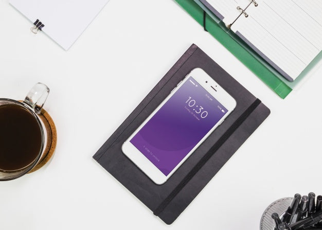 Smartphone Mockup With Office Materials On Table Psd