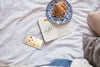 Smartphone On Bed With Diary And Croissant Psd