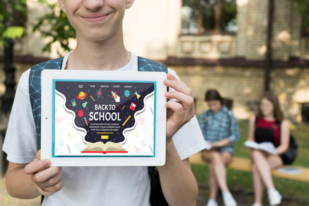 Smiley Boy Holding A Tablet Mock-Up Psd