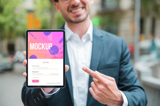 Smiley Businessman Holding And Pointing At Tablet Psd