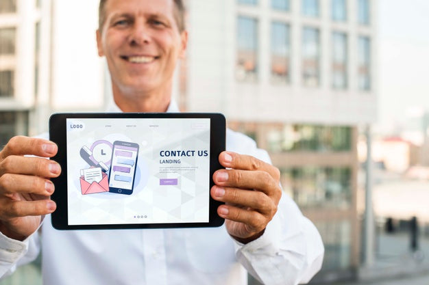 Smiley Businessman Outdoors Holding Horizontal Digital Tablet Psd