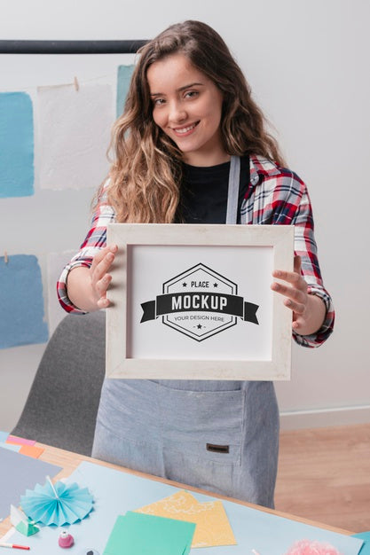Smiley Female Artist Holding Mock-Up Frame Psd