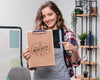 Smiley Female Artist Holding Mock-Up Notepad And Pointing At It Psd