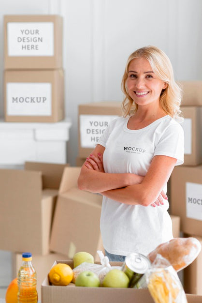 Smiley Female Volunteer Posing Next To Food Box Psd