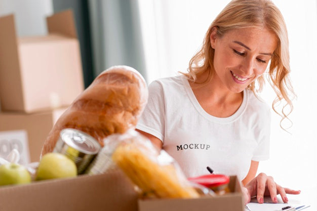 Smiley Female Volunteer Writing Down Food For Donation Boxes Psd
