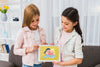 Smiley Girls Holding A Tablet Mock-Up Psd