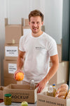 Smiley Male Volunteer Preparing Donation Box With Provisions Psd