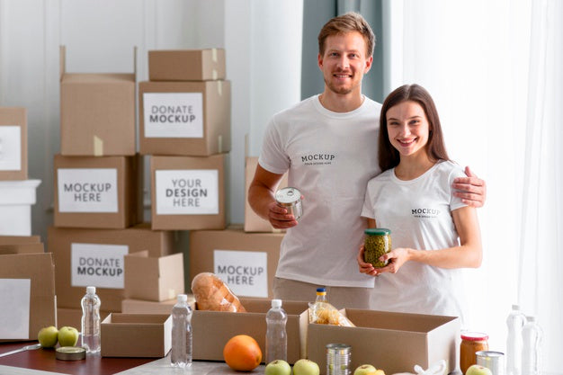 Smiley Volunteers Posing Together While Preparing Boxes Of Provisions For Donations Psd